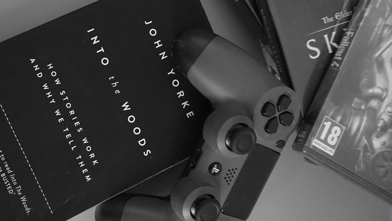 A copy of John Yorke's Into the Woods, a PS4 controller and PS4 games
