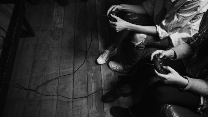 Two gamers sitting on a sofa article feature